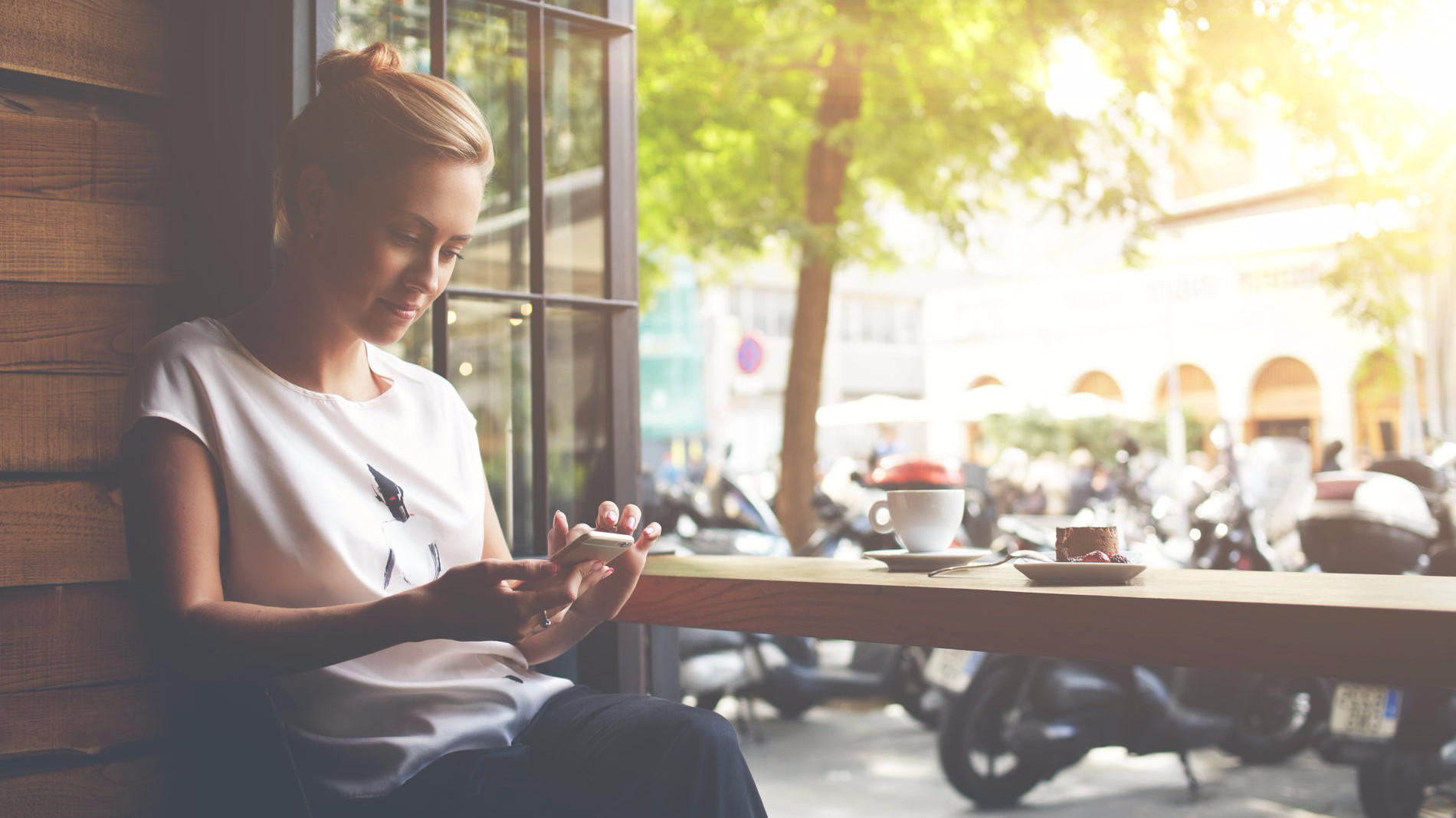 woman sitting and using her phone