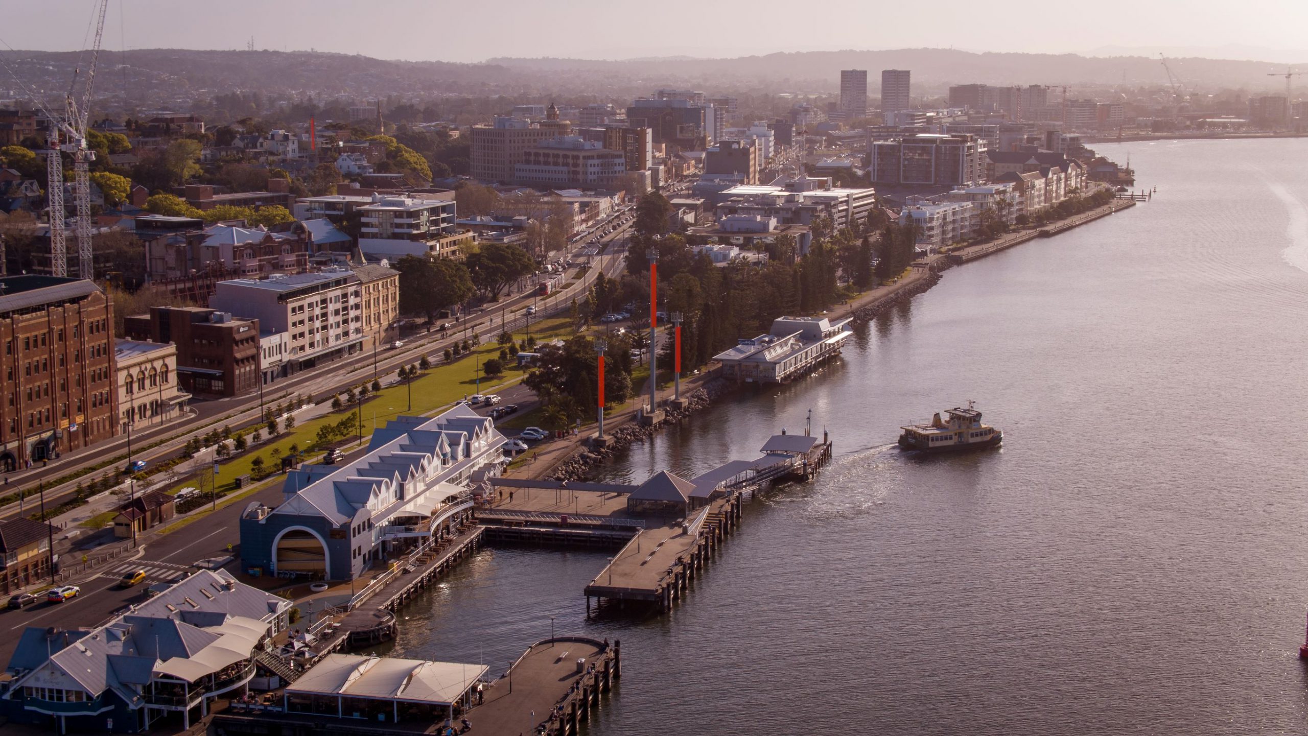 Aerial view of Newcastle Harbour showing city including the ferry and light rail