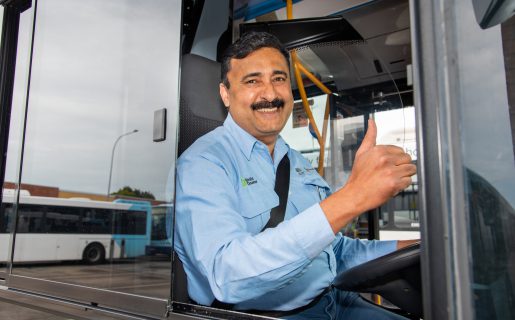 Bus driver Jay smiling and giving a thumbs up