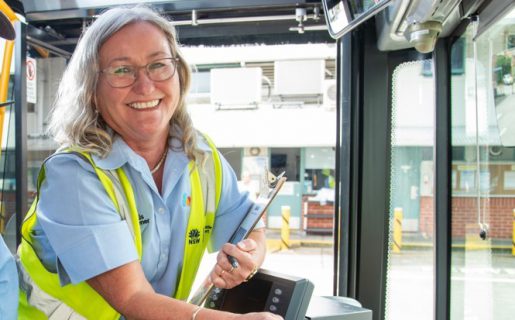 Bus driver Lisa helping to train a new driver and smiling
